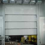 Vertical Lift Acoustic 4-Leaf Door for heavy mining truck manufacturing facility